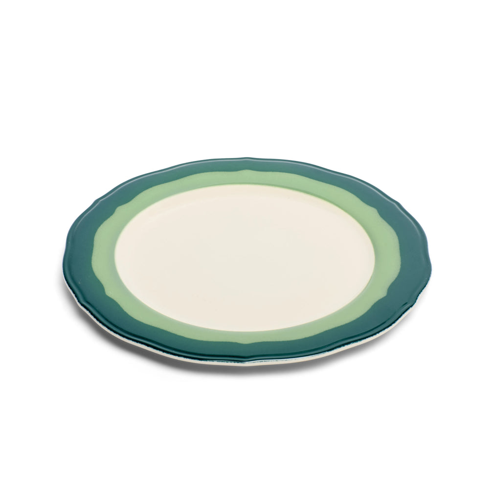Scalloped salad plate with two-tone teal and seagreen rim, angled to show the wavy edge