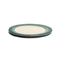 Two scalloped teal and seagreen salad plates stacked, low side view showing the profile