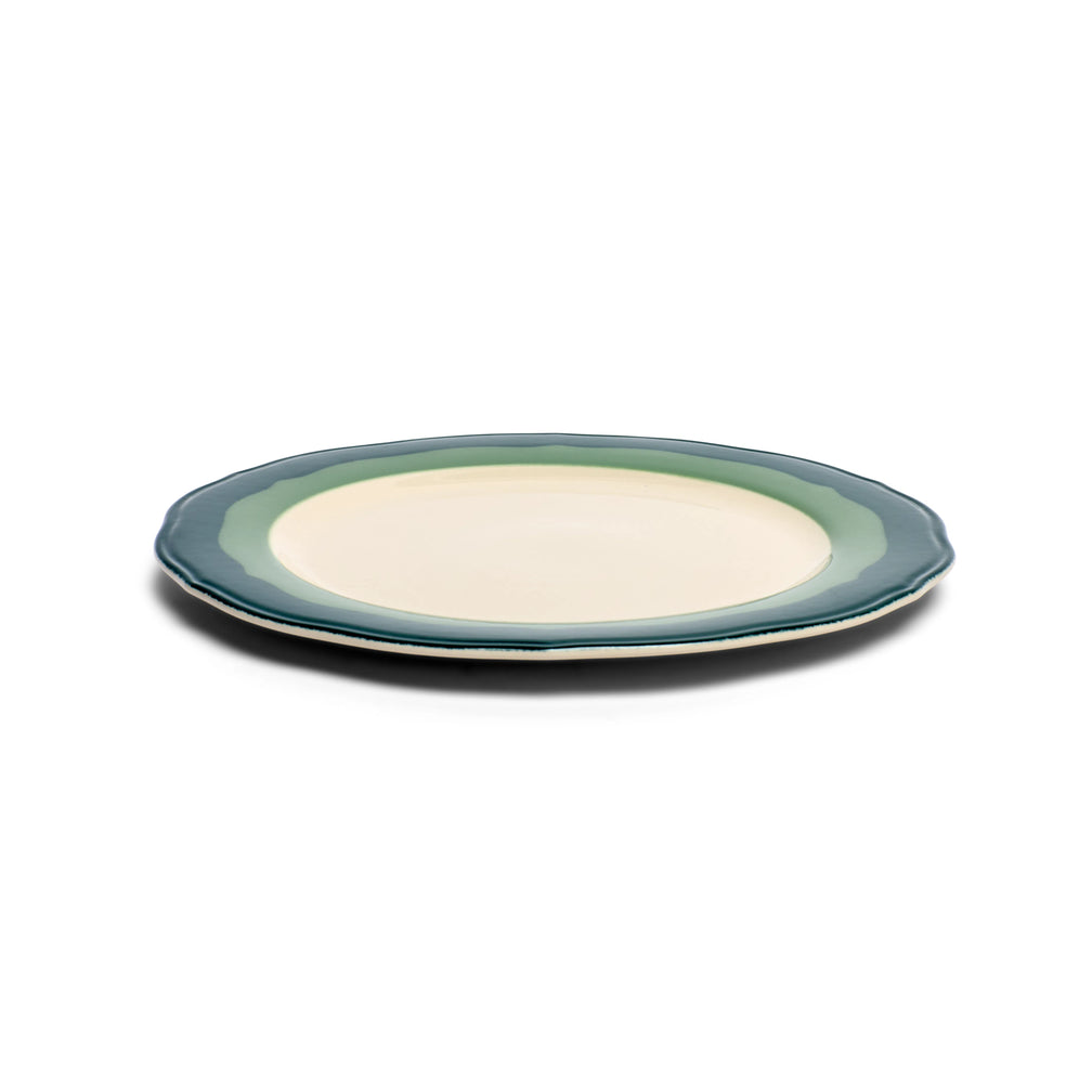Two scalloped teal and seagreen salad plates stacked, low side view showing the profile