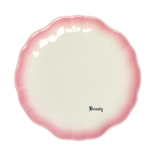 Pink and white ceramic dish with 'Beauty' text on a white background