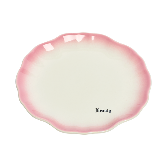Pink and white ceramic dish with 'Beauty' text on a white background