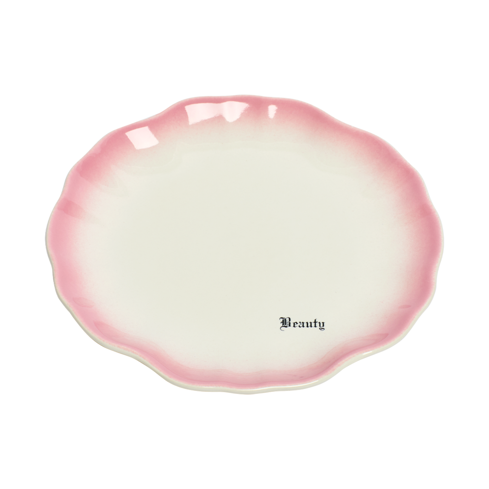 Pink and white ceramic dish with 'Beauty' text on a white background