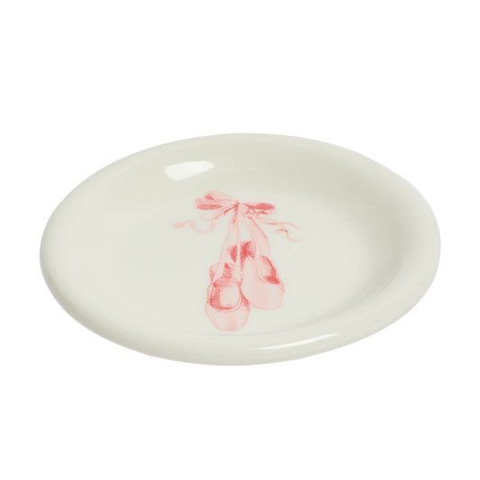 Round ceramic plate with pink ballet shoes design on a white background