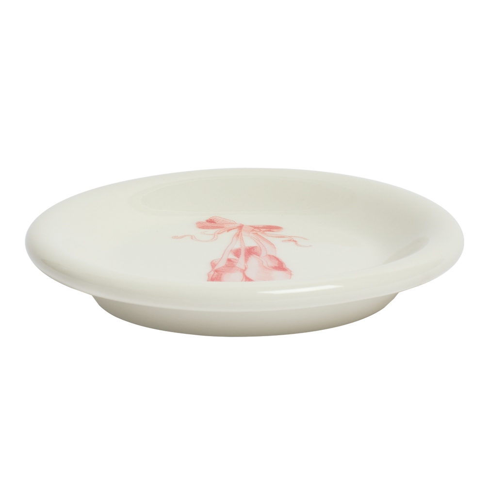 White ceramic plate with a pink floral design on a white background
