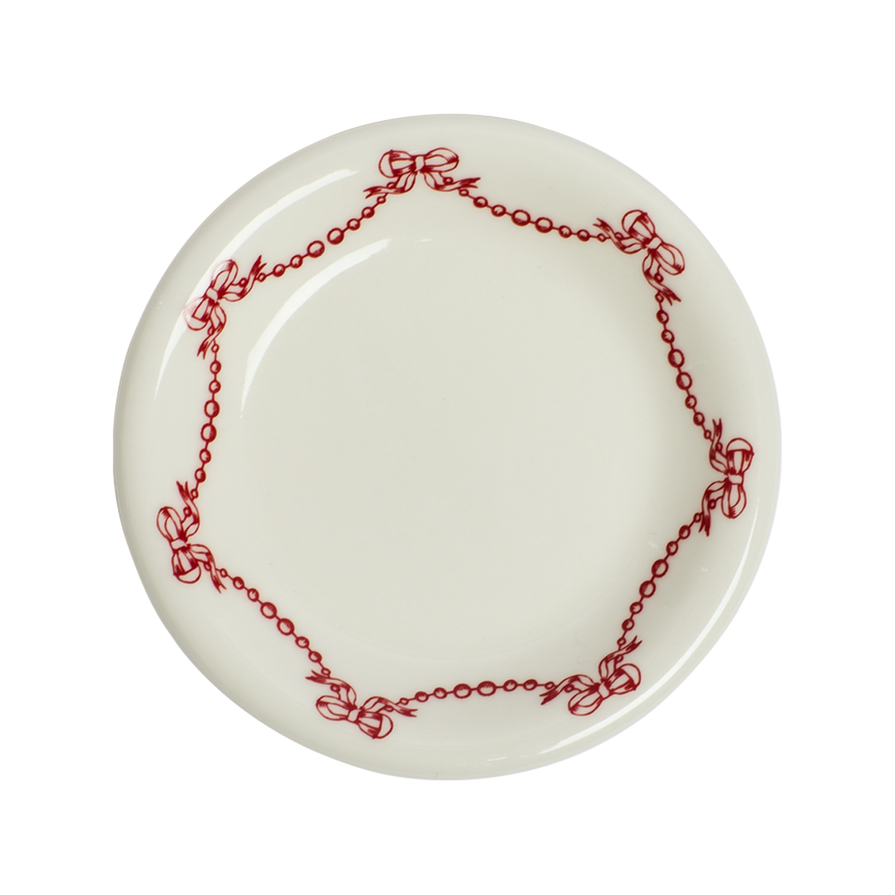 White plate with red decorative border on a white background