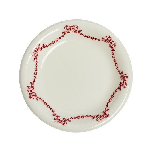 White plate with red decorative border on a white background