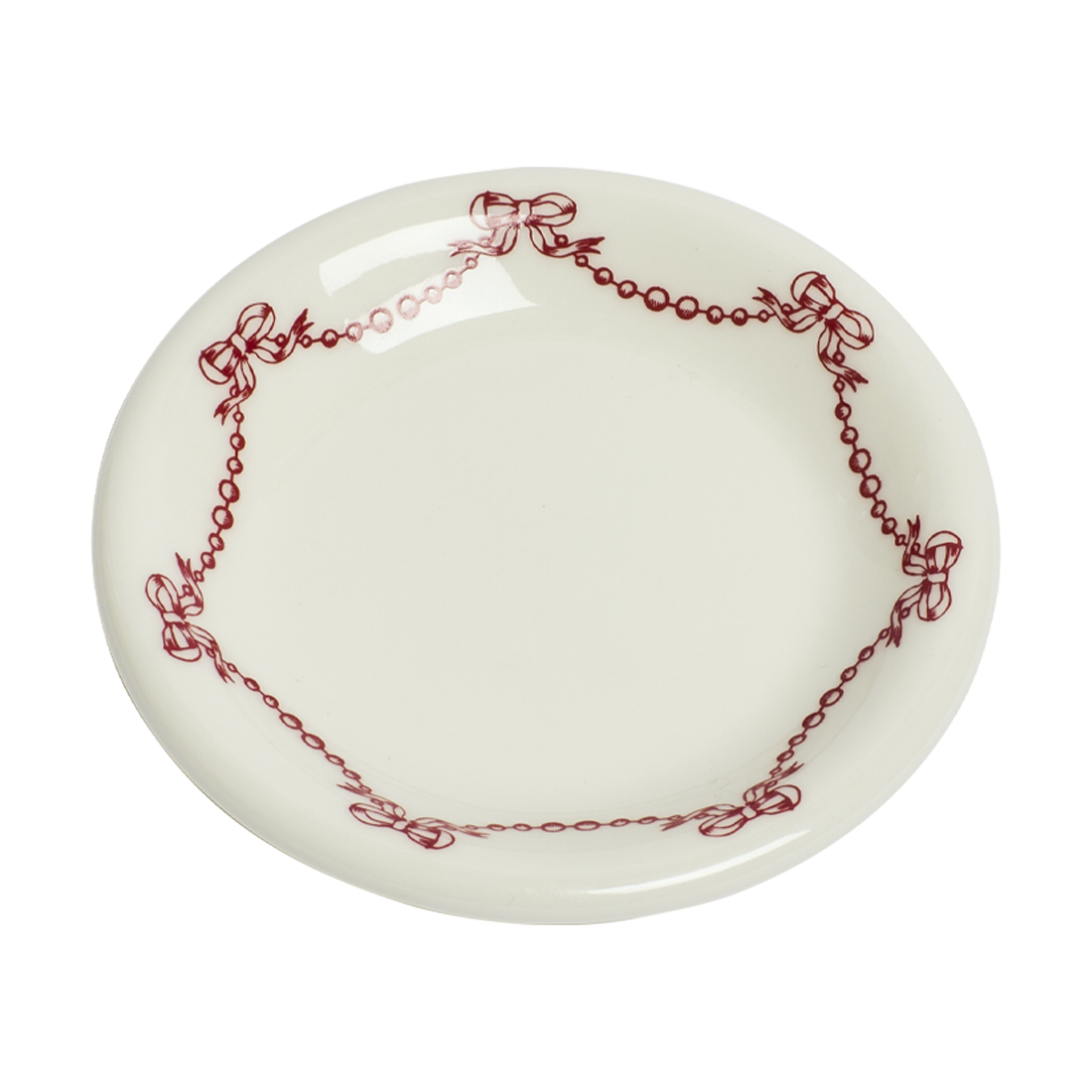 White plate with red decorative border featuring bows on a white background