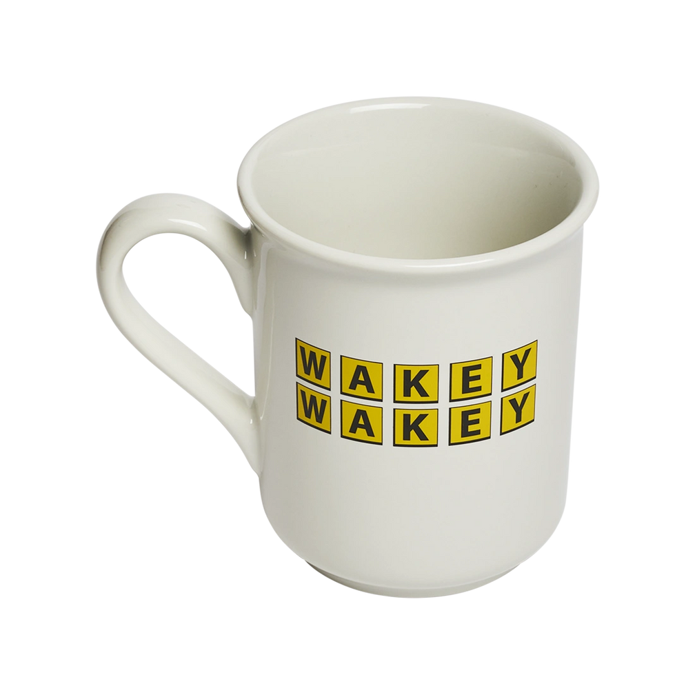 Novelty coffee mug featuring bold “WAKEY WAKEY” typography on durable white ceramic. Fun gift mug for coffee drinkers, tea lovers, coworkers, and anyone who is not naturally a morning person. Three-quarter view.