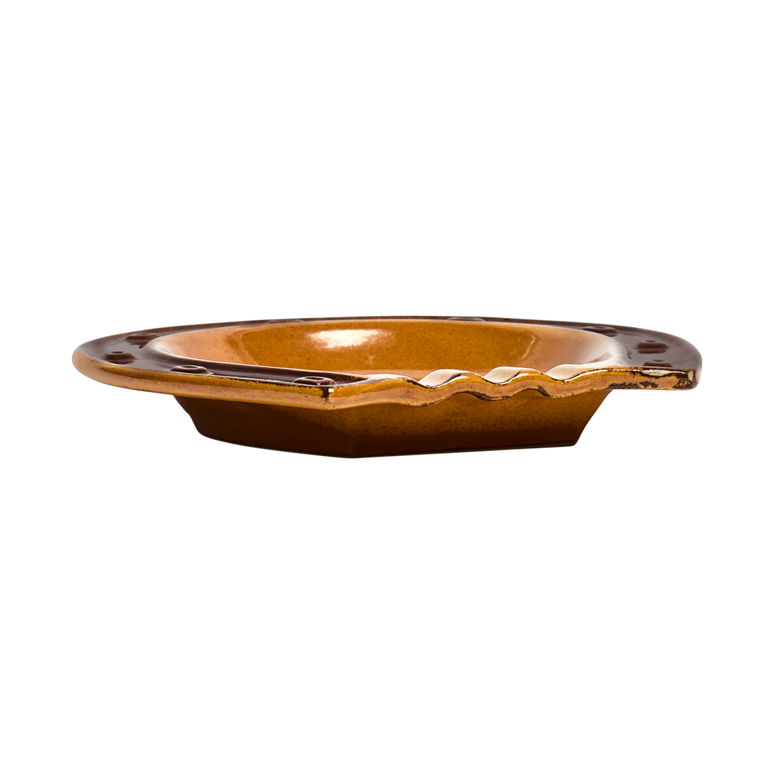 Brown ceramic dish with wavy edge on a white background