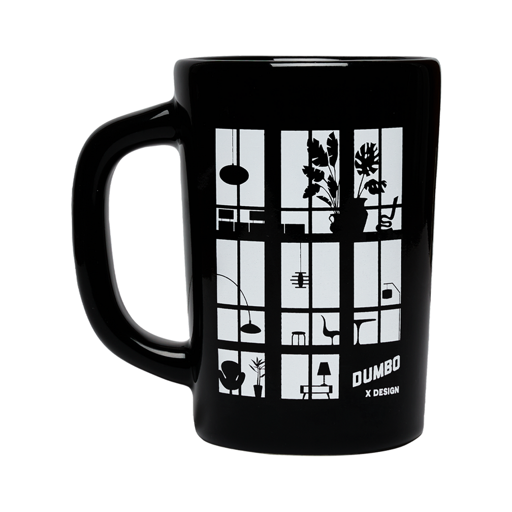 Black mug with white design featuring geometric shapes and 'Dumbo x Design' text on a white background