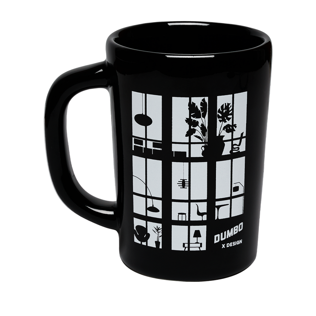 Black mug with white design and 'Dumbo' branding on a white background