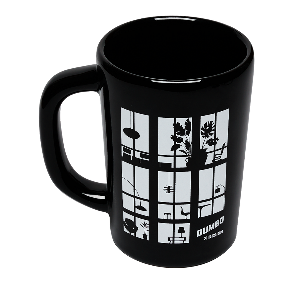 Black mug with white window design and 'Dumbo Design' text on a white background