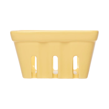Front view of a yellow ceramic berry basket with open slotted sides, designed for displaying berries, cherry tomatoes, garlic, or small produce.