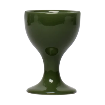 Front view of a green ceramic egg cup with a sturdy pedestal shape, sized to hold a soft-boiled egg for breakfast or brunch.