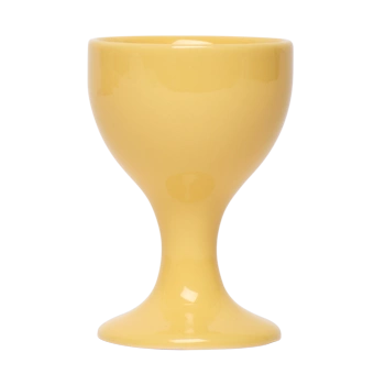 Front view of a yellow ceramic egg cup with a sturdy pedestal shape, sized to hold a soft-boiled egg for breakfast or brunch.