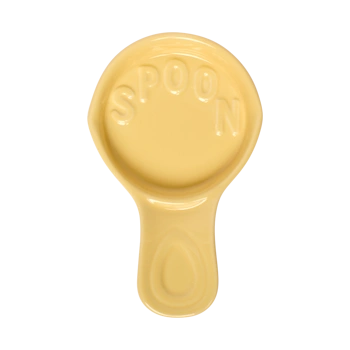 Top view of a yellow ceramic spoon rest with raised decorative details and a shallow basin to catch drips beside the stove.