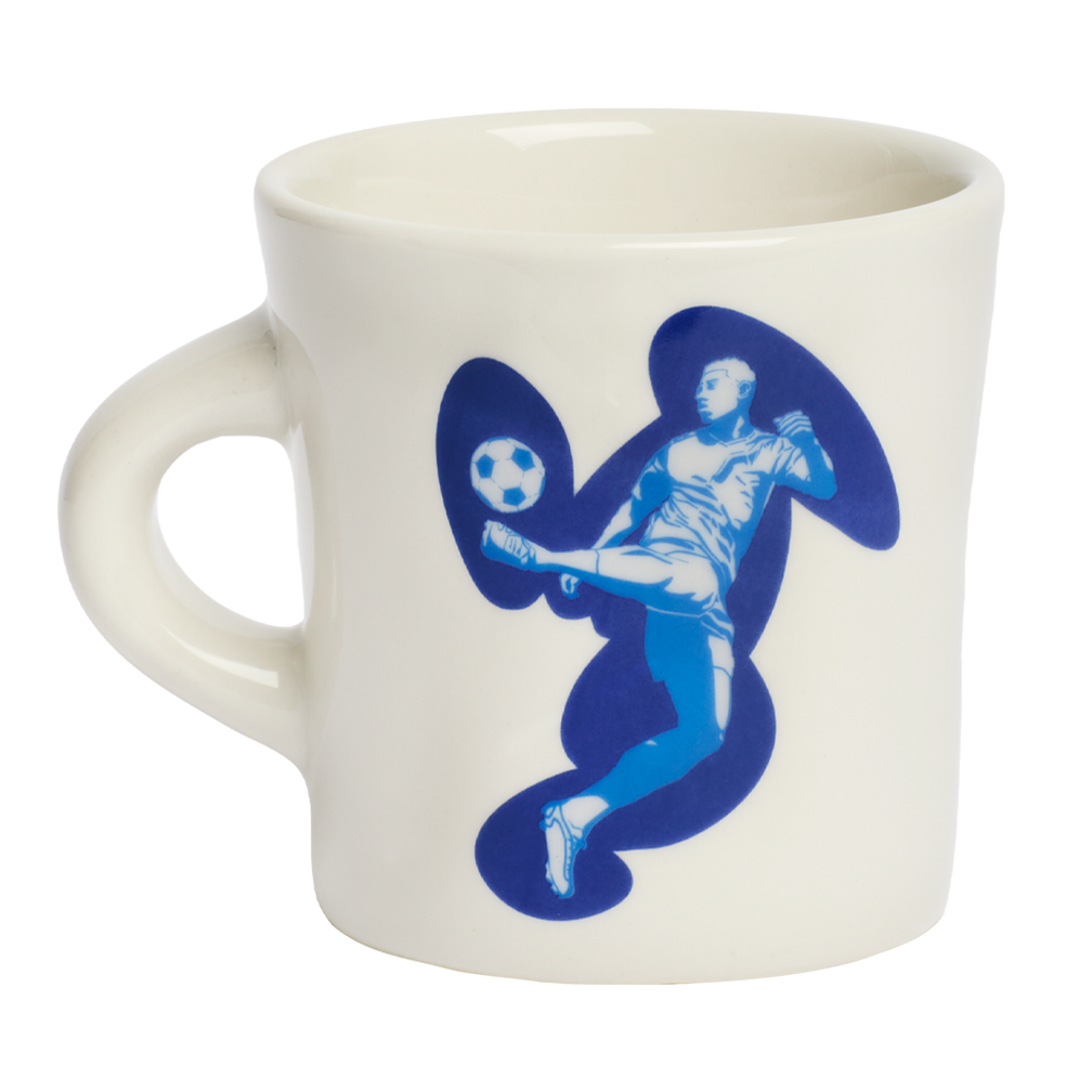 Ceramic coffee mug with illustrated soccer player design in blue tones, a playful addition to modern kitchen collections and casual dining spaces