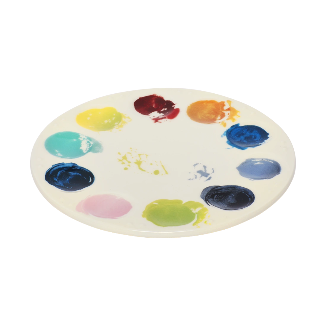 Artist palette ceramic plate with vibrant painted color swatches around the edge, designed to resemble a painter’s palette. Unique art-inspired serving plate for cheese boards, desserts, and creative table settings. Angled view.