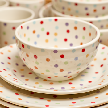 Set of polka dot bowls and plates on a white background