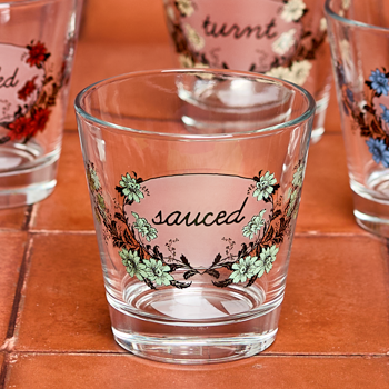 Clear glass with 'sauced' design on a wooden surface