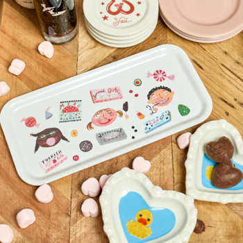 Set of colorful coasters with cartoon designs on a wooden surface