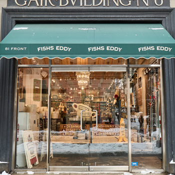 Storefront with 'Fishes Eddy' branding on a green awning.