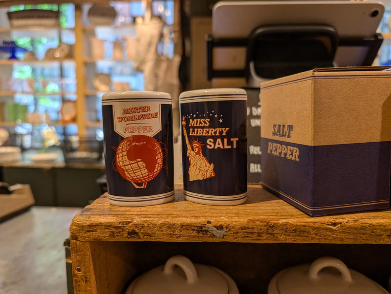 Miss Liberty salt and Mister Worldwide pepper shakers on display with their box